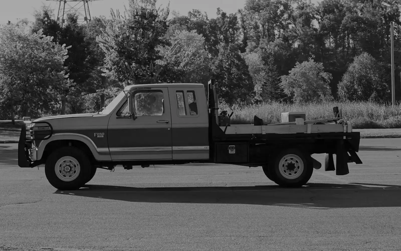 Flatbed work truck parked at a jobsite